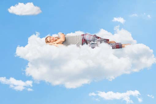 young woman sleeping peacefully on a cloud